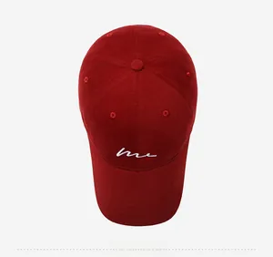 Top view of burgundy cotton baseball cap featuring white 'me' script embroidery and curved brim