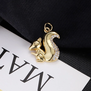 Macro shot of gold-plated squirrel pendant with white rhinestones and a top loop
