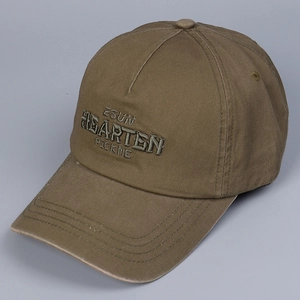 Detail of embroidered letter logo on khaki cotton baseball cap with reinforced stitching