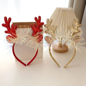 Detailed view of red and gold glitter reindeer antlers headbands for Christmas parties