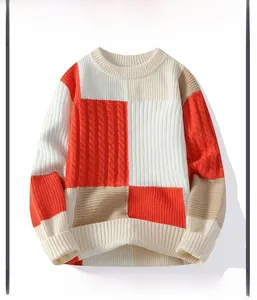 Detail of color-block knit sweater featuring textured cable patterns and ribbed cuffs