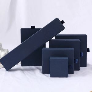 Navy blue drawer jewelry gift boxes in various sizes on white textured background