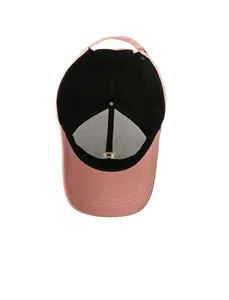Detail view of pink baseball cap interior showing black sweatband and adjustable metal strap