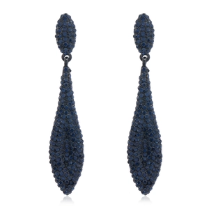 Macro shot of blue crystal teardrop earrings with dark metal base and luxury pavé setting
