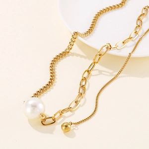 Golden heart necklace with shell pendant and white pearl on elegant layered link chain