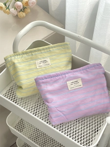 Detailed macro view of striped canvas storage bags in lilac and macaron yellow colors