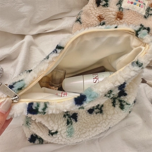 Detailed interior of plush floral makeup bag showing large storage capacity and fabric lining