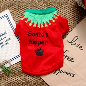 Detail of red Christmas dog shirt with Santa's Helper text and green jagged collar