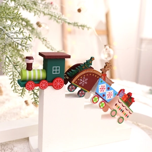 Colorful wooden Christmas mini train decoration with festive ornaments on white steps