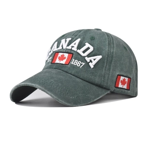Detail of embroidered Canada letters and flag on washed dark green cotton baseball cap