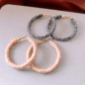 Handmade wool knit round hoop earrings in grey and nude pink for autumn and winter