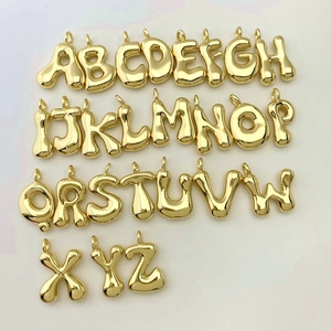 Detailed full set of 26 3D bubble alphabet pendants in polished gold finish on white background