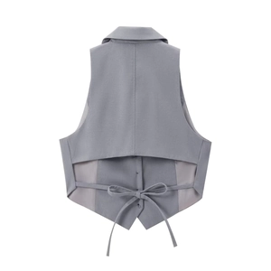 Detail of grey open back vest with bow tie design on clean white background
