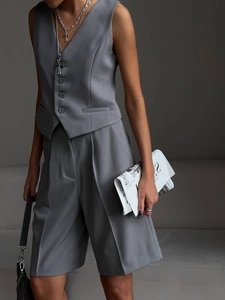 Gray V-neck vest and straight-leg shorts suit with refined fabric texture and silver necklaces
