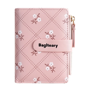 Pink quilted PU leather short wallet for women featuring white floral print and zip closure