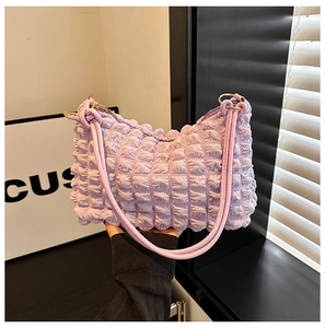 Detail of light purple bubble textured fabric and metallic rings on a chic tote bag