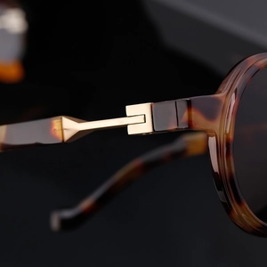 Macro shot of durable metal hinges on tortoiseshell round frame sunglasses