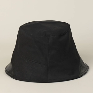 Detailed view of black cotton bucket hat featuring a sleek leather brim and fine stitching