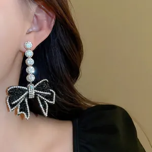 Silver needle bow earrings with black stones and sparkling round zircon accents