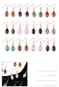 Macro detail of marquise faceted amethyst stone earrings with silver bezel and hook wire