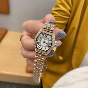 Close-up of elegant tonneau dial watch with rhinestone bezel and metal chain strap