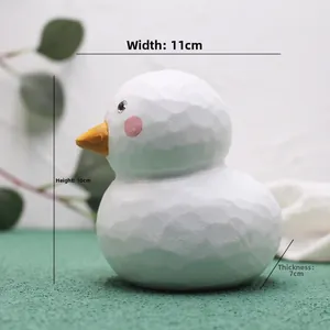 Detailed view of white bird figurine with geometric faceted texture and dimensions