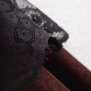 Elegant black lace patchwork trousers for women featuring a minimalist straight-leg design