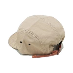 Detail of khaki 5-panel camper hat featuring metal eyelets and adjustable strap