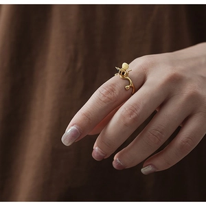 Artistic S925 silver bee ring with natural agate and golden branch design on finger