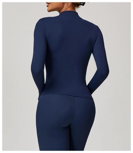 Back view of slim-fit dark blue long-sleeve yoga jacket and high-waist athletic leggings