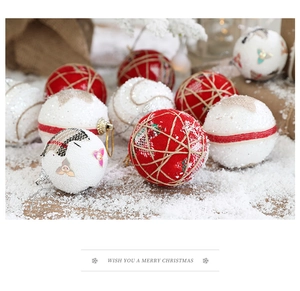Detail of red and white glitter foam Christmas ornaments on a festive snow-covered wood surface