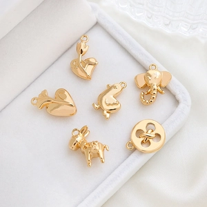 Golden elephant and heart shaped charms set in jewelry box for DIY necklaces