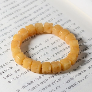 Detailed view of cheese-shaped yellow beads on a creative Bodhi root bracelet