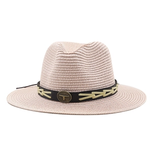 Pink Panama straw hat with wide brim and vintage bronze bull head metal emblem decoration