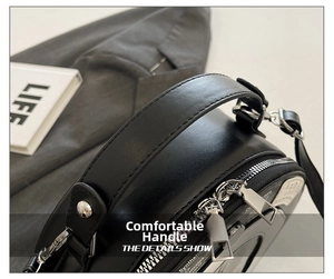 Detailed close-up of a black vintage round bag showing smooth faux leather and silver zipper
