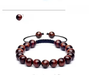 Detail of 10mm red tiger eye beads on adjustable black braided cord with silk luster