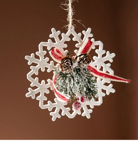 Macro view of snowflake ornament with natural pine cones, pine needles and red berries