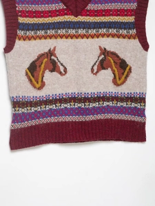 Detail of V-neck knitted vest with horse pattern and Fair Isle geometric jacquard texture