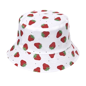 White reversible bucket hat featuring cute red strawberry embroidery and black polka dots