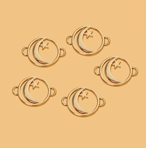 Detail of five gold alloy crescent moon and star connectors for DIY jewelry making