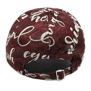 Detail of burgundy baseball cap rear featuring jacquard fabric and silver metal buckle