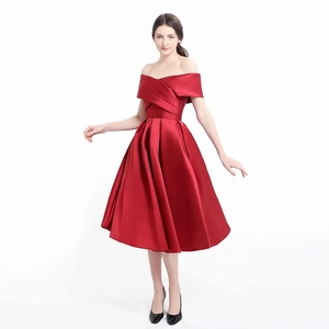 Detail of elegant off-shoulder red satin evening dress with pleated waist and flared skirt