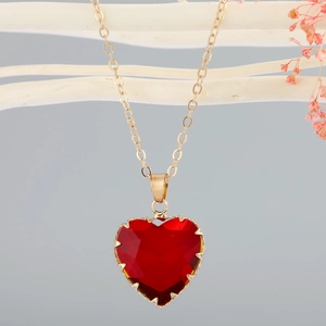 Elegant heart necklace featuring a large red faceted crystal pendant on a gold chain