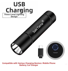 Detail of portable black metal LED flashlight showing USB charging port and cable