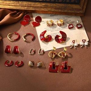 Close-up of vintage red enamel and gold metal earrings in French retro style