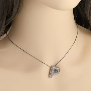 Elegant silver necklace with sparkling rhinestone paved letter P pendant on model