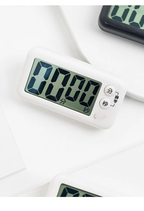 Detail view of white magnetic kitchen timer with LCD display and physical control buttons