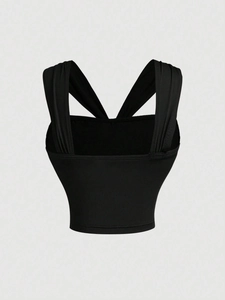 Slim fit black tank top for women featuring criss-cross back straps and metal buckle