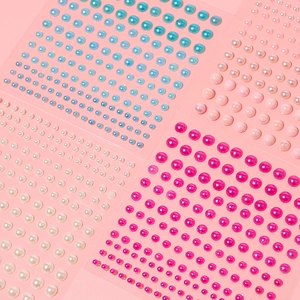 Detail of colorful self-adhesive half round pearl stickers for hair and nail art decoration