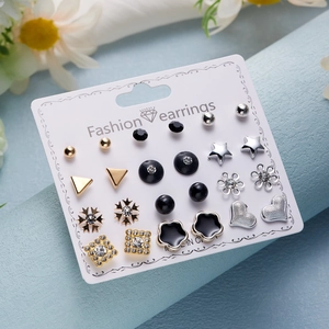 Close-up of 12-pair earring set featuring heart, star, and flower motifs with crystal accents